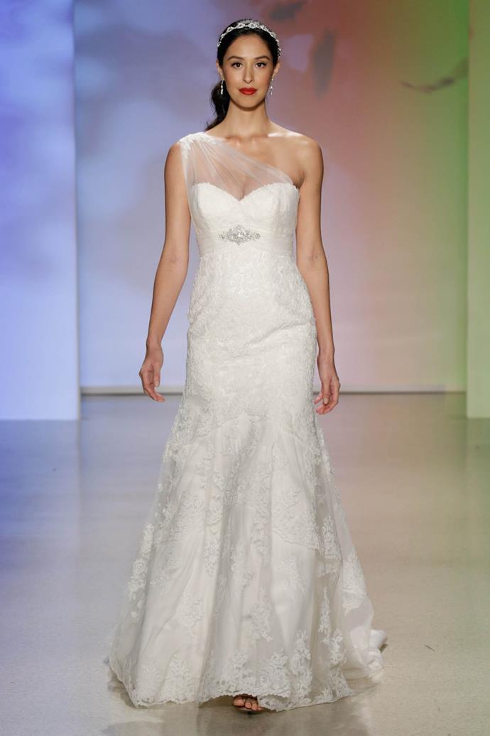 Traditional lace, a sophisticated fit and flare silhouette and Pocahontas' signature one-shoulder neckline come together to create a wedding dress that is as strong as the heroine herself.