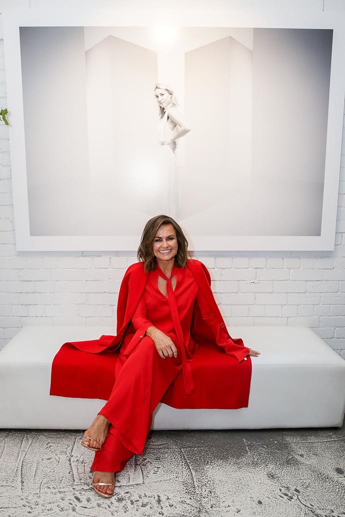 Super classy in this caped scarlet jumpsuit.