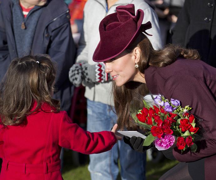 Meeting the crowds: Catherine accepts some flowers from a young girl.