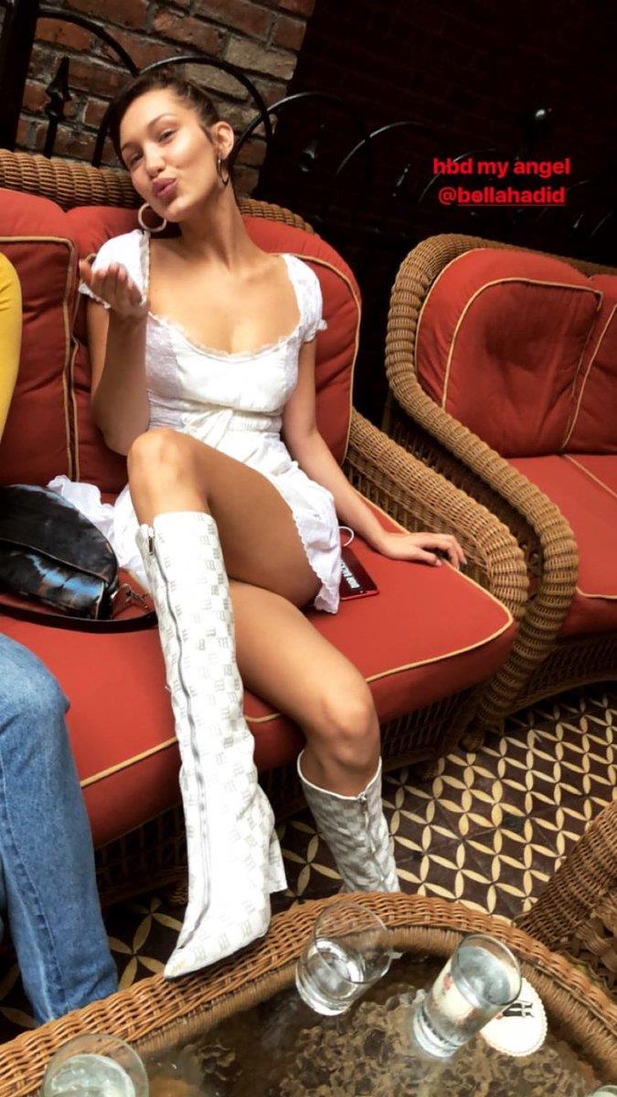Bella Hadid wore a Little House on The Prairie dress with matching white knee-high boots for a lunch during the day.
