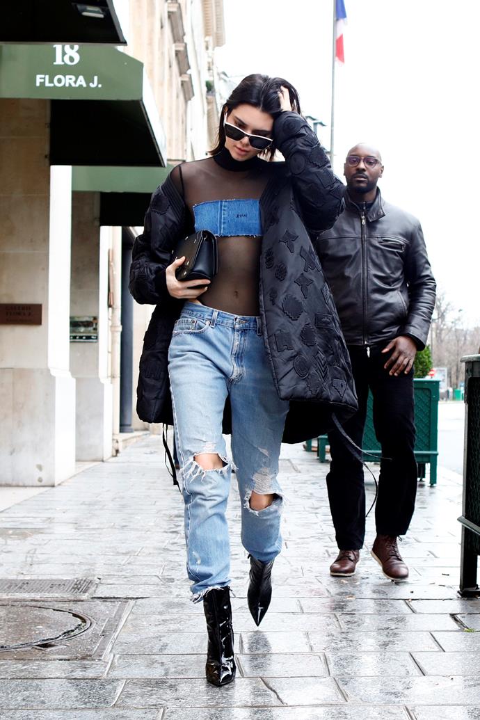 In a sheer top and distressed jeans in Paris.