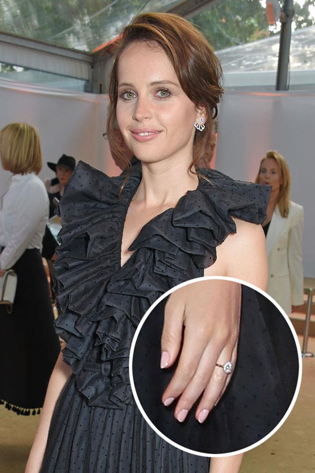 ***Felicity Jones.***<br><br>
Felicity Jones got engaged to her long-time boyfriend Charles Guard in March 2018, and her engagement ring, which has a round diamond and gold band, made its red carpet debut in London. It perfectly accessorised her Dior dress.