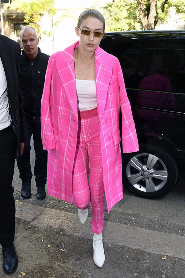 Gigi Hadid stepped out in Milan wearing a hot pink plaid Fendi suit, toeing the line between Cher and Barbie.