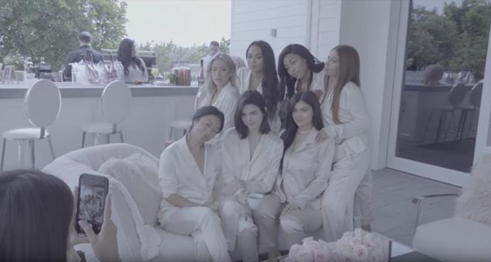 A group of friends huddle around Kylie Jenner at her baby shower—including Jordyn Woods, Stassie, Yris Palmer and sister, Kendall Jenner.