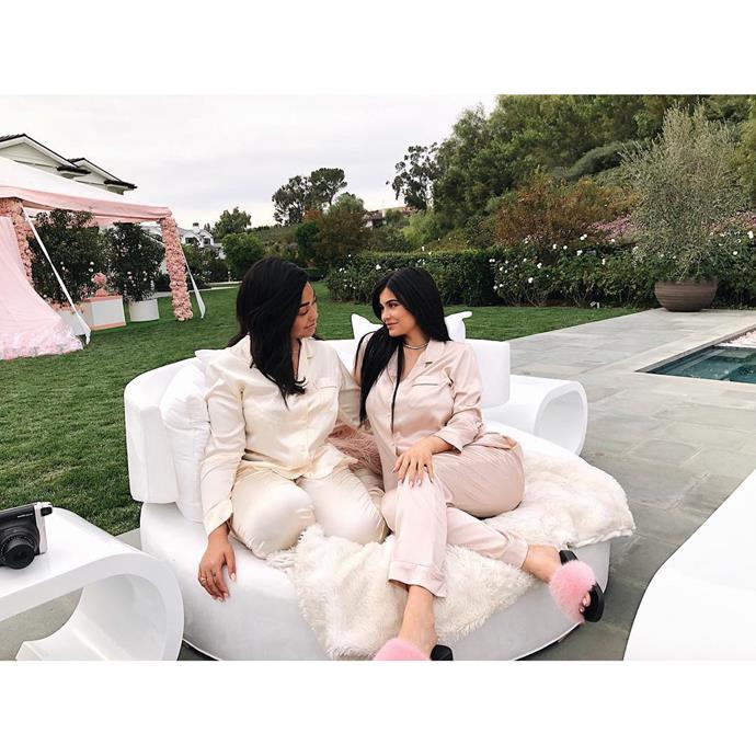 Best friends, Kylie Jenner and Jordyn Woods, smile at each other at Kylie Jenner's baby shower.