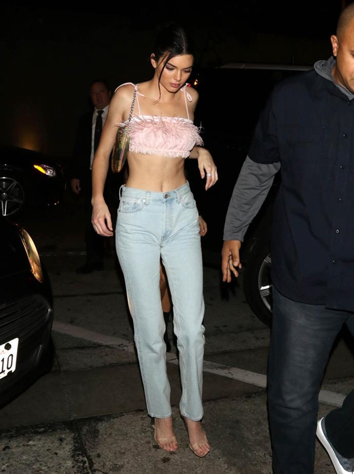 Kendall Jenner steps out wearing a baby pink feather crop top while out and about in Los Angeles with her sister Kourtney Kardashian on February 18, 2018.