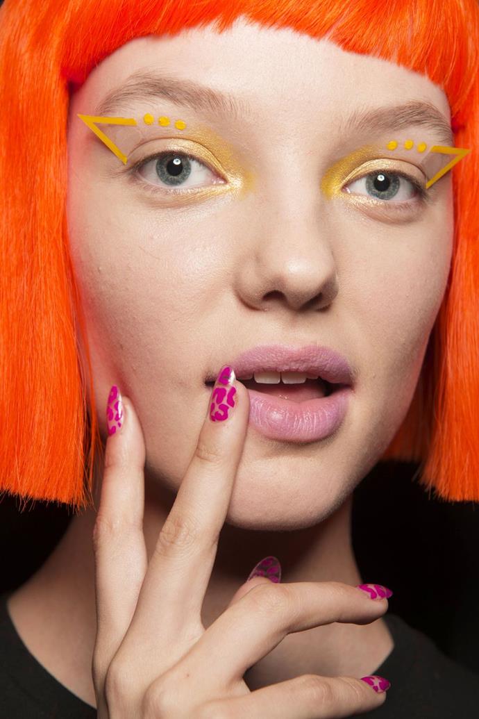 **Jeremy Scott**
<br><br>
**The Vibe:** Neon Leopard
<br><br>
**Get the Look:** Inspired by Scott's colorful designs, nail artist Miss Pop for Essie opted for a neon animal print pattern on the nails. Miss Pop used one of three polishes: [Tart Deco](https://www.adorebeauty.com.au/essie/essie-nail-colour-tart-deco-88.html|target="_blank"|rel="nofollow") (coral), [Play Date](https://www.priceline.com.au/essie-nail-color-13-5-ml|target="_blank"|rel="nofollow") (violet), or Bachelorette Bash (hot pink), drawing macaroni shapes or single dots on the nail to fill in empty space.