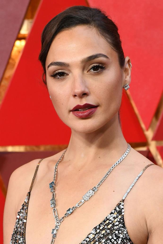 **Gal Gadot**
<br>
Actress Gal Gadot embodied old school glamour on the red carpet. Gadot is quite fond of a red lip and we are really enjoying this darker shade on her.