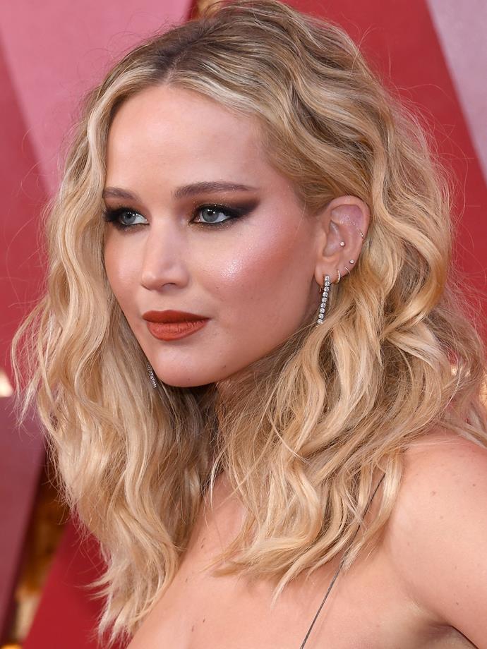 Jennifer Lawrence's left ear has at least six piercings, including four along her lobes, a conch and a helix.