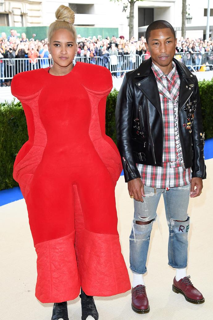 **2017: HELEN LASICHANH in Comme des Garçons**
<br><br>
Pharrell's wife Helen Lasichanh sacrificed limb mobility in favour of an iconic sartorial moment at 2017's *Comme des Garçons*-themed gala. 
<br><br>
Lasichanh looked the perfect contradiction to her husband's relaxed Chanel get-up, and, as one of the first arrivals, the twosome set the tone for the bevy of fashion moments to come later in the evening.