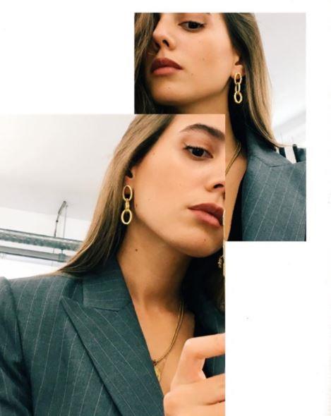 **Gold dangly earrings**

The key is picking earrings that aren't *too* dangly, but just dangly enough. Think three to four centimetres below your ear lobe, max. 

(Photo: Instagram/Sarah Nait).