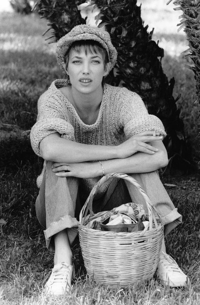 In an oversized jumper, white sneakers and a pageboy cap, with her signature basket.