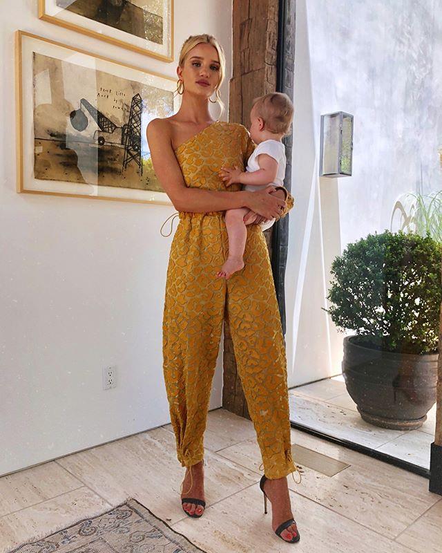 Wearing a one-shoulder marigold yellow Stella McCartney jumpsuit in Los Angeles on June 16, 2018