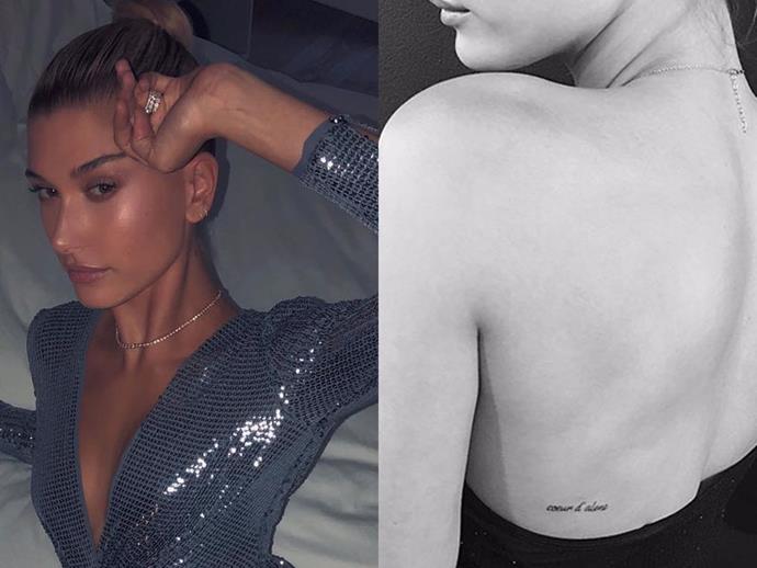 **HAILEY BIEBER**
<br><br>
Bieber got the french words "Coeur d'Alene" in 2017—which translates to 'Heart of Alene'—tattooed on her back.