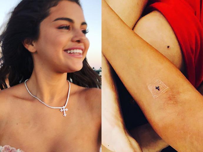 **SELENA GOMEZ**
<br><br>
To commemorate her best friend Courtney Lopez's 26th birthday, the singer had a tiny cross tattooed on her forearm.