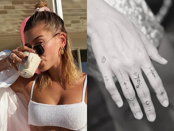 **HAILEY BIEBER**<br><br>

Hailey Bieber is a big fan of tiny tattoos (she has around 20 of them). One of her most notable ones includes this set of stars, moons and decorative motifs, accompanied by the letter *B*, courtesy of celebrity tattoo artist [Dr. Woo](https://www.instagram.com/p/B1hbZC1nf_1/|target="_blank"|rel="nofollow").