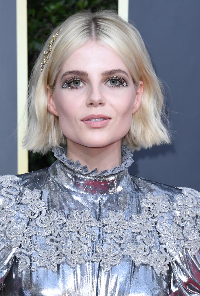 A diehard fan of matching her makeup to her outfit, she commited to the metallic cause with a gilded hair pin and an art deco-inspired glitter cateye, anchored by her sky-high lashes and a muted pale nude lip.
