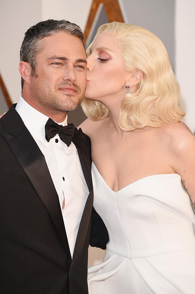 **Lady Gaga and Taylor Kinney** <br><br>
While Gaga is no longer in a relationship with actor Taylor Kinney, the couple met on the set of Gaga's 2011 music video, "Yoü and I", where Kinney played her love interest. <br><br>
In a 2015 interview on *[Watch What Happens Live! with Andy Cohen](https://www.youtube.com/watch?v=zm2UQdZDOzs|target="_blank"|rel="nofollow")*, Kinney said of their unconventional first meeting: "I remember I went up, and we're rolling, and I kissed her and she didn't expect it. They cut, and she slapped me. And then it was just awkward. And then the next take, I just did it again and then she didn't slap me. She didn't slap me then."
