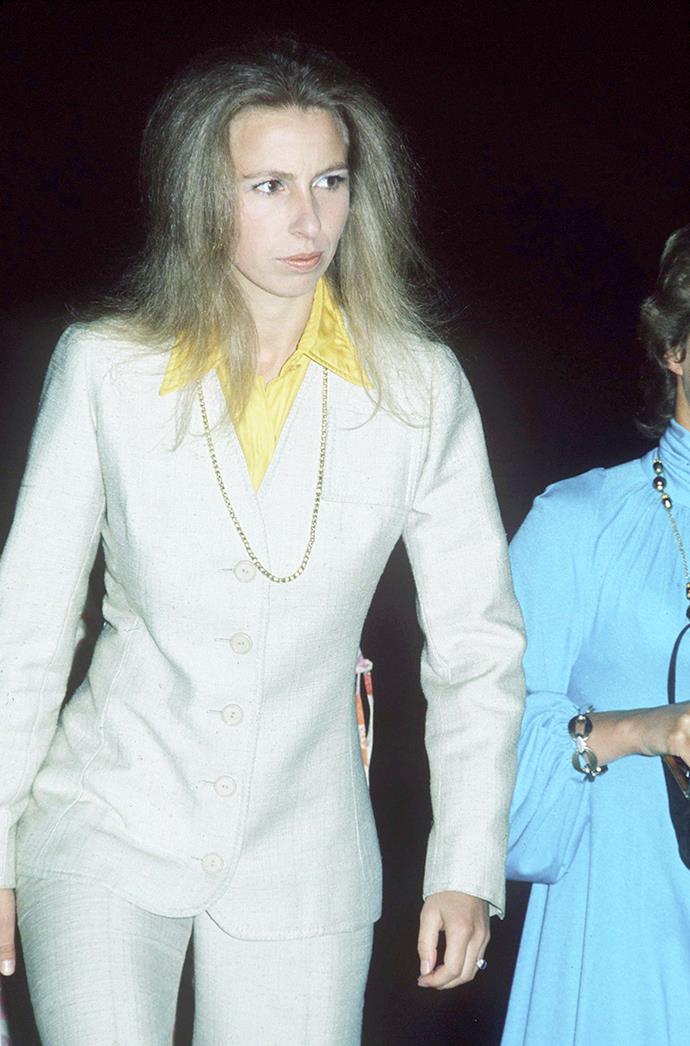 **PRINCESS ANNE**
<br><br>
Back in 1973, Princess Anne's trip to the theatre with a friend, saw her reign champion of the pantsuit. She paired this look with a yellow shirt and long gold chain for the ultimate '70s look.