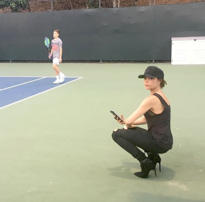 Victoria Beckham playing tennis in six-inch heeled boots.