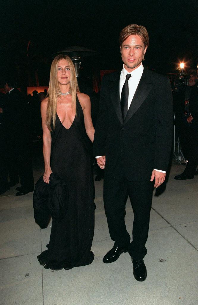**Jennifer Aniston & Brad Pitt, 2000**
<br><br>
It It-couple of the time arrived in matching black, with Aniston in a plunging gown while Pitt opted for a sleek suit. The choker and sleek straight hair really transition this look to the early aughts.