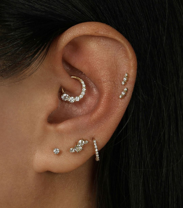 Left to right, bottom to top from Sarah & Sebastian: [VIER DIAMOND CARTILAGE EARRING](https://www.sarahandsebastian.com/collections/earrings/products/vier-diamond-cartilage-earring-yellow-gold|target="_blank") ($240), [DIAMOND GRAVITY CARTILAGE EARRING](https://www.sarahandsebastian.com/collections/earrings/products/diamond-gravity-cartilage-earring-gold|target="_blank") ($1,100), [DEMI DIAMOND HOOP](https://www.sarahandsebastian.com/collections/earrings/products/demi-diamond-hoops-yellow-gold|target="_blank") ($695), [OUROBOROS DIAMOND DAITH EARRING](https://www.sarahandsebastian.com/collections/earrings/products/ouroboros-diamond-daith-earring-yellow-gold|target="_blank") ($1,450)