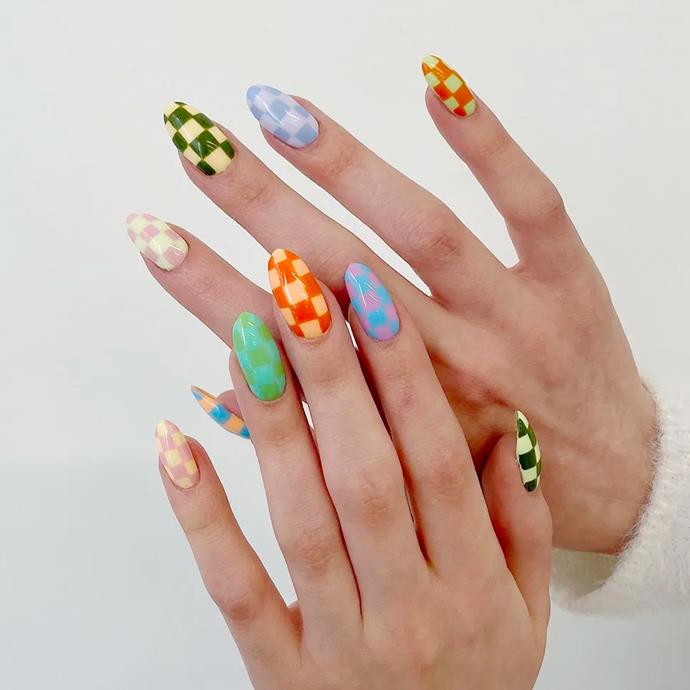 **Multiple Checkerboards**
<br><br>
Unless you've been hiding under a rock, [checkerboard nails](https://www.elle.com.au/beauty/checkerboard-nail-art-trend-24383|target="_blank") have become a must-have for manicure maniacs throughout 2021. But for the upcoming year, mix-and-matching the trend on the one hand is on the menu. If you have a steady hand, God speed. If not, we suggest opting for a professional's touch to nail this look.
<br><br>
*Image: [@yeswhatnails](https://www.instagram.com/yeswhatnails/|target="_blank"|rel="nofollow")*