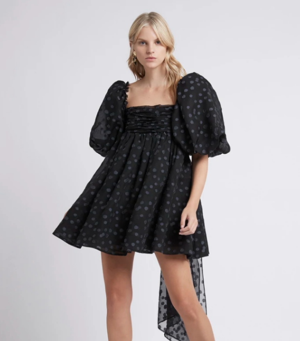 La Piscine Puff Sleeve Bow Back Mini Dress, $495 at [Aje](https://ajeworld.com.au/collections/dresses/products/la-piscine-puff-sleeve-bow-back-mini-dress-black
|target="_blank") 
