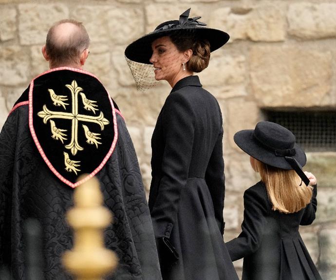 Princess Kate and Princess Charlotte walk hand-in-hand into Queen Elizabeth II's funeral at Westminster Abbey.