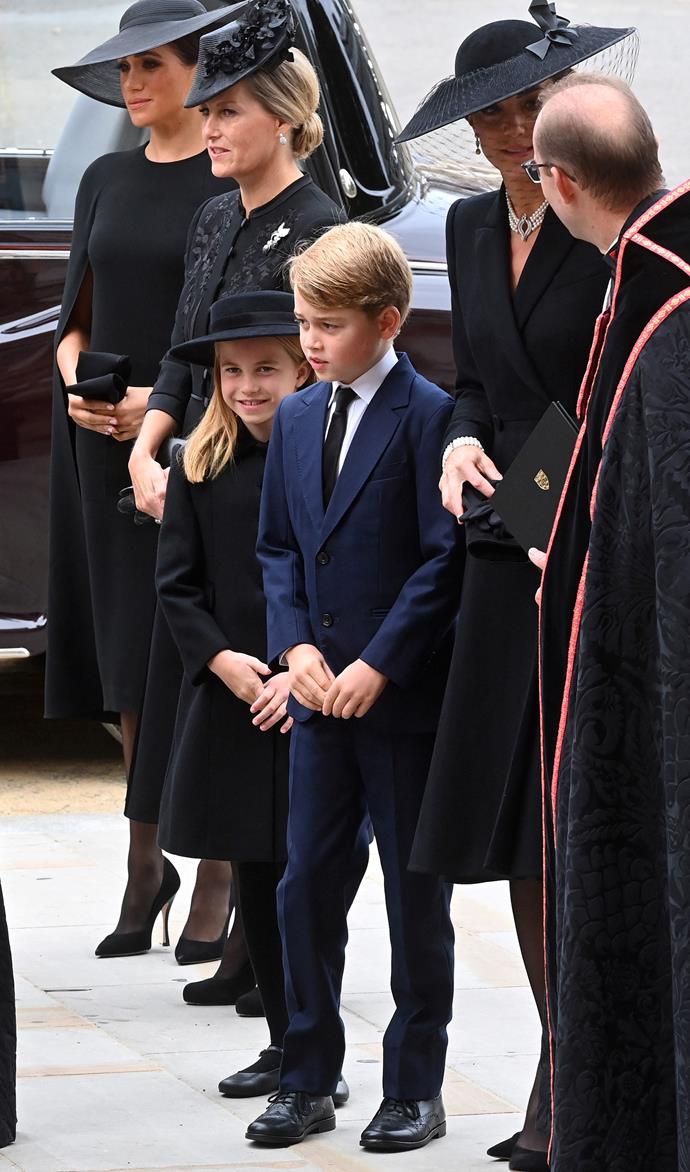 Meghan, Duchess of Sussex, Princess Charlotte, Prince George and Princess Kate arrive at Queen Elizabeth II's funeral.