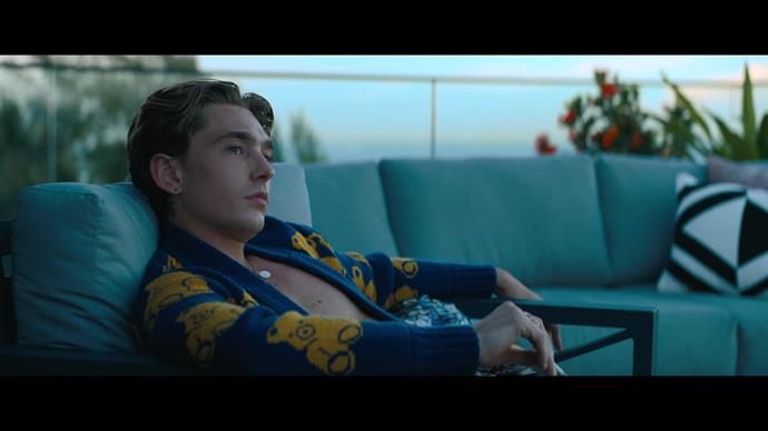 Austin Abrams appeared in a thrifted Gucci cardigan, embroidered with teddy bears. Morshead scored this piece second-hand off eBay for $300. 
<br><br>
"It was about trying to get creative, because I don't have the money to do this, but it still needs to be great," Morshead told *[The Daily Beast](https://www.thedailybeast.com/obsessed/the-do-revenge-costumes-were-inspired-by-clueless-and-cruel-intentions?ref=scroll|target="_blank"|rel="nofollow")*. 
<br><br>
"That's when as the designer, you ask, 'How do we figure this out?' It's not like we have all this money and can buy all this cool stuff."