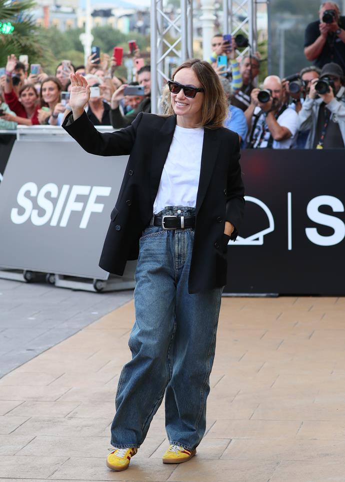Once again, the actress was doing the most at the San Sebastián International Film Festival, this time cutting a more casual figure while still looking incredibly put together. 
<br><br>
Wilde wore a black, double-breasted Balenciaga tuxedo jacket, paired with a Khaite Mae t-shirt, chunky Benny leather belt, oversized jeans from Preen and a pair of  Adidas x Gucci Gazelle Sneakers. Many felt that she was channelling [boyfriend Harry Styles](https://ellaau.com/celebrity/harry-styles-olivia-wilde-still-together-27635|target="_blank") with this outfit, and honestly, we see it.
