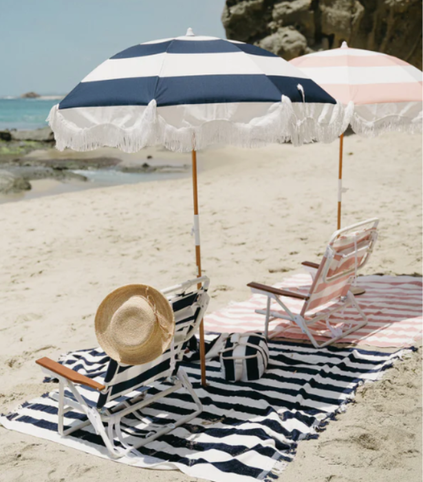 **The Classic Beach Umbrella**<br><br>

There's nothing quite like a classic candy-coloured beach umbrella for those balmy weekends. Offering almost two metres of shade, UPF 50+ fabric and a carry bag for easy portability, it's the ultimate all-rounder for long sea-side days.<br><br>

*'The Holiday Beach Umbrella by Business & Pleasure, available in various colours, $199.99 at [Business & Pleasure](https://businessandpleasureco.com.au/|target="_blank"|rel="nofollow")*