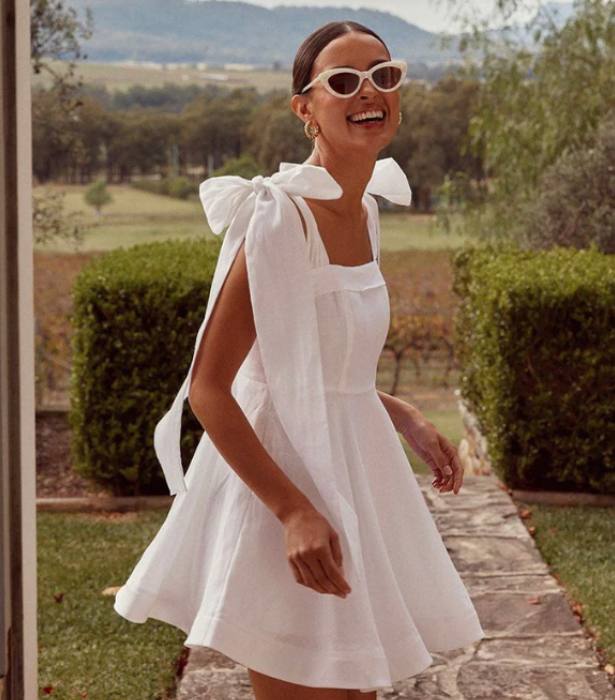 Aisle White Linen Bow Mini Dress, $189.99 at [DISSH](https://dissh.com.au/products/preorder-white-linen-bow-mini-dress|target="_blank"|rel="nofollow") <br>
[SHOP NOW](https://dissh.com.au/products/preorder-white-linen-bow-mini-dress|target="_blank"|rel="nofollow")