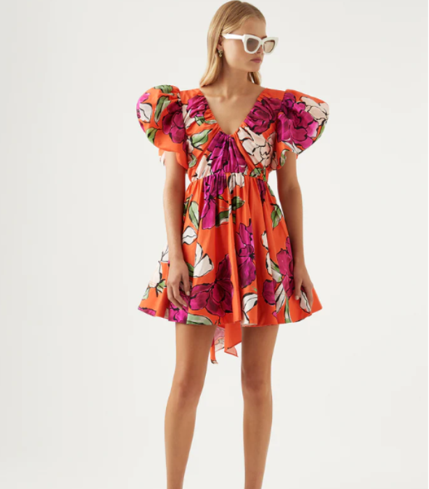 Gretta Bow Back Mini Dress, $475 at [Aje](https://go.linkby.com/ESXYIGCG/collections/dresses/products/gretta-bow-back-mini-dress-vivid-camellia|target="_blank"|rel="nofollow") <br>
[SHOP NOW](https://go.linkby.com/ESXYIGCG/collections/dresses/products/gretta-bow-back-mini-dress-vivid-camellia|target="_blank"|rel="nofollow")