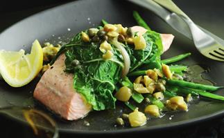 steamed salmon in spinach with lemon, olive and caper sauce
