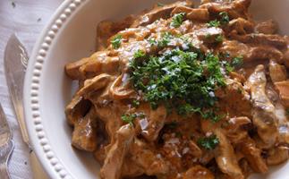 Venison stroganoff with saffron cap mushrooms and oven-baked chips