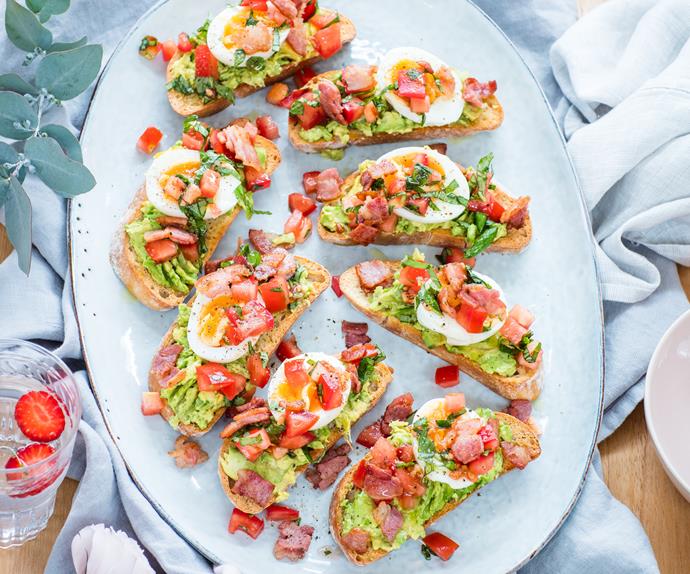 Brunch bruschetta with bacons, eggs and smashed avocado