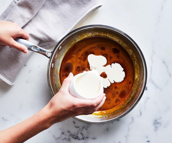 **Step 3** 

Carefully pour in **125gm cream**. Stir to combine, being careful of the steam and the bubbling caramel, then stir in **another 125gm cream**. Remove from heat and switch from a wooden spoon to a whisk.