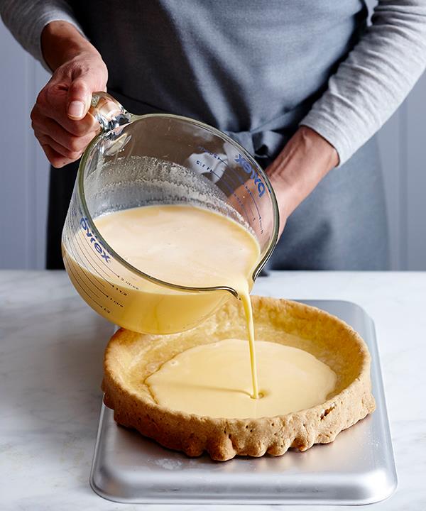 Half-fill the tart with custard