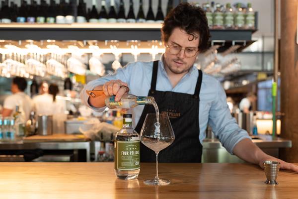 James Irvine, Four Pillars' creative director of gin drinks, pouring the Four Pillars Olive Leaf Gin.
