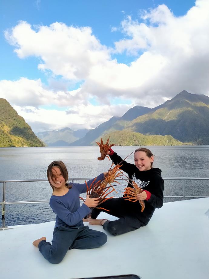 Bayly's two children showing off their catch of the day, crayfish, caught at Doubtful Sound, Fiordland.