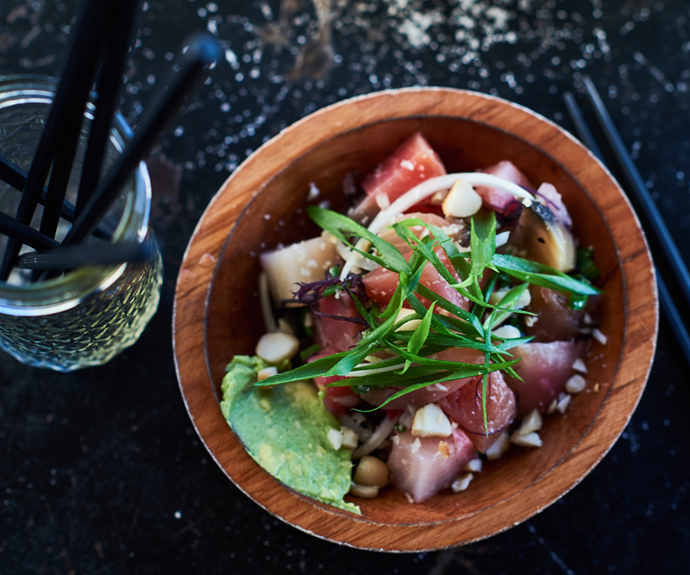 A gourmet poke bowl with ahi and salad.