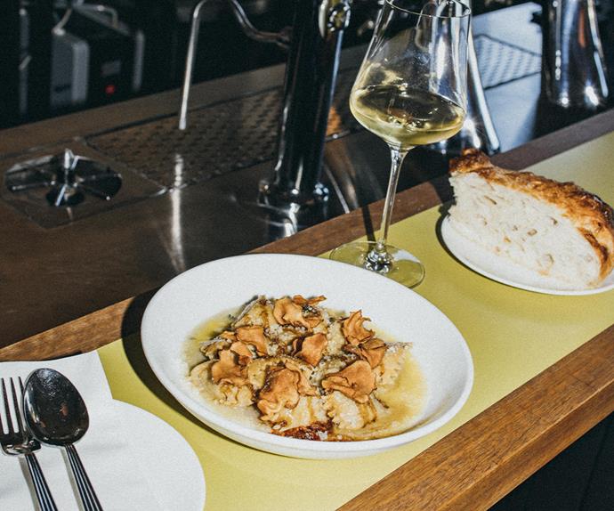 Casa, Perth in WA . Photo of a plate of pasta with mushrooms at the bar Served with focaccia and a glass of white wine.