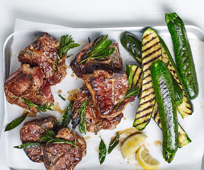 An aerial view of grilled lamb chops and grilled zucchini with lemon and rosemary.