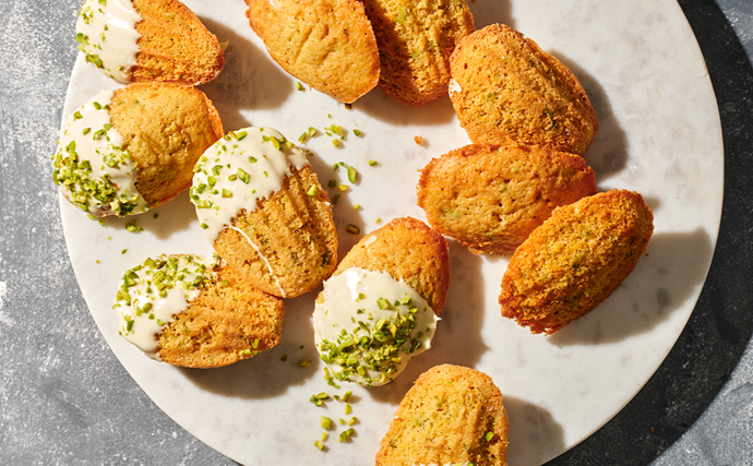 An aerial view of lemon myrtle brown butter madeleines on a circular white plate 