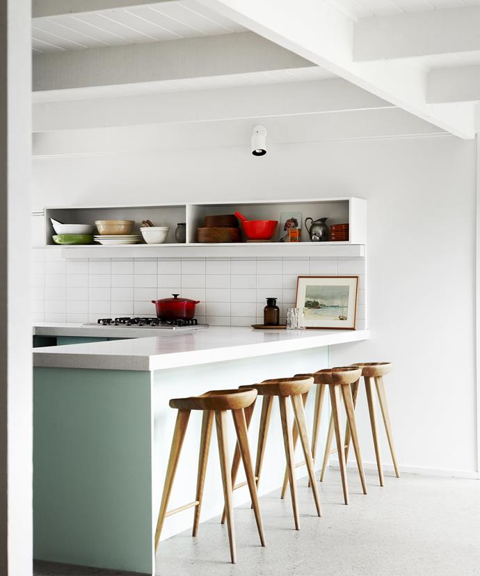 The kitchen – and the rest of the original 1970s house – was updated with a lick of white paint. Vinyl and carpet floors were stripped back, with the existing concrete floors polished to unify the spaces.