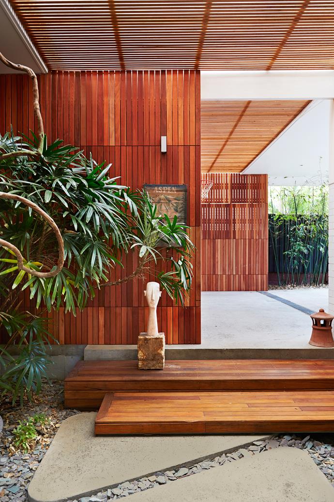 The exterior of this Bondi Beach home introduces a mix of tactile materials. Here, cleverly detailed hardwood battens wrap the carport and entrance.