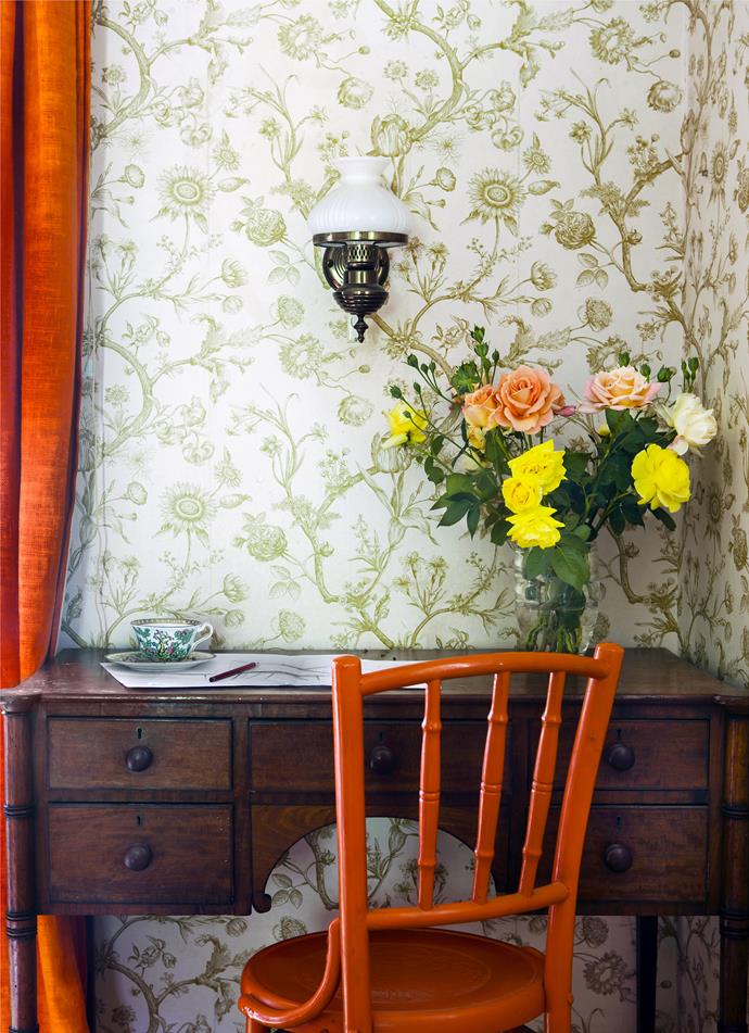 In the guestroom are orange hessian curtains hand-dyed by Charles' mother. The roses were picked from the garden planted by his grandmother some 50 years ago. The teacup is a souvenir from her travels in China around the same time.