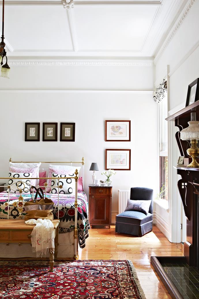 The wrought-iron bed in the master bedroom was bought at a market.